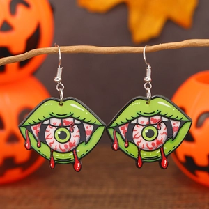 Boucles d'oreilles Halloween avec lèvres vertes et yeux injectés de sang sur citrouille
