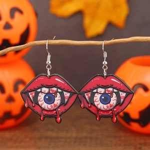 Détail de boucles d'oreilles d'Halloween avec lèvres rouges, dents et œil sanglant