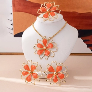 Exaggerated hollow orange flower jewelry set with gold-edged necklace, ring and earrings