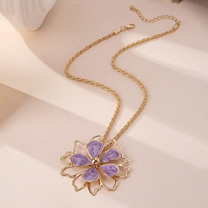Detail showing gold rope chain with purple enamel flower pendant and lobster clasp closure