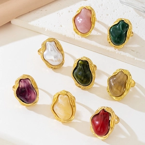 Detail view of gold lava texture rings with multi-colored baroque resin inlays