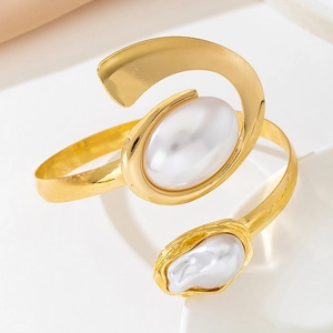 Detail of gold-plated starfish bangle with asymmetric white imitation pearls