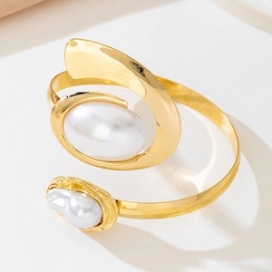 Detail of gold starfish bangle with large oval pearl and small baroque pearl accents