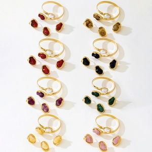 Detailed macro shot of various bohemian gold bangles with colorful resin stone accents