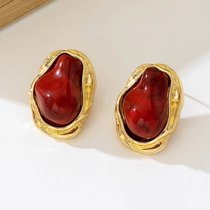 Vintage gold metal earrings with deep red marble texture in a bohemian geometric style
