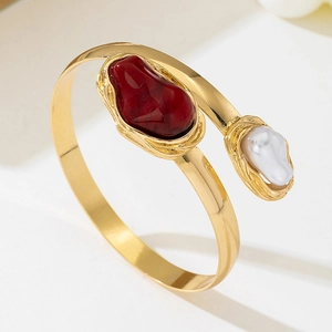 Bohemian adjustable gold cuff bracelet with red resin stone and baroque pearl detail
