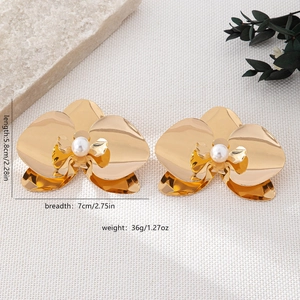 Detailed view of large orchid earrings in gold finish with pearl and size measurements