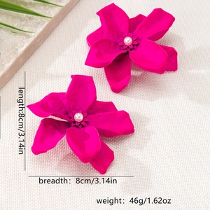 Detail of oversized magenta flower earrings with a central pearl and 8cm measurements