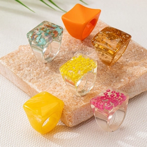 Chunky geometric resin rings set in colorful transparent styles with golden foil flakes