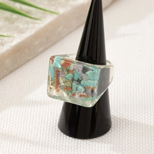 Detailed view of square resin ring with embedded turquoise and purple mineral stones