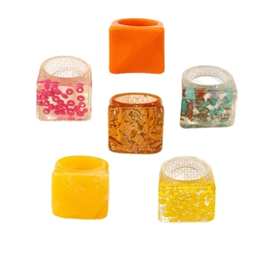 Set of six colorful chunky resin rings in geometric square shapes on white background