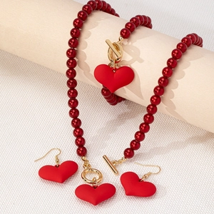 Vintage red heart jewelry set with beaded necklace, bracelet, and earrings with OT buckles
