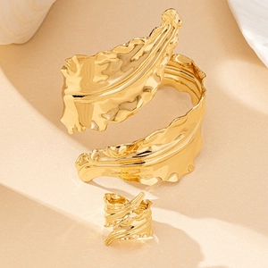 Golden organic leaf-shaped adjustable ring and cuff bracelet set with hammered texture
