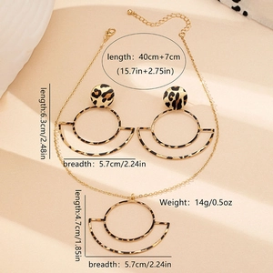 Detail view of leopard print geometric pendant necklace and large circle earrings set
