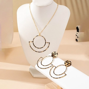 Golden geometric circle pendant necklace and earrings set with trendy leopard print texture