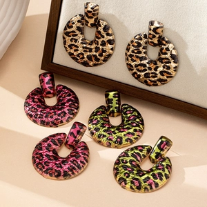 Three pairs of textured leopard print hoop earrings in gold, pink, and neon green colors