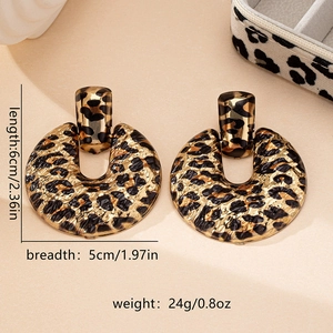 Detail view of large leopard print earrings showing dimensions 6cm x 5cm and 24g weight