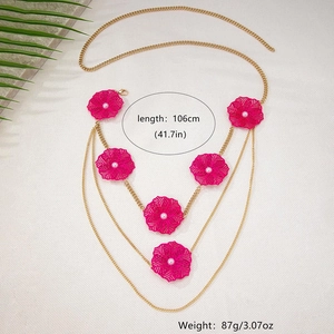 Detail of bohemian gold waist chain with rose red hollow flowers and pearl centers