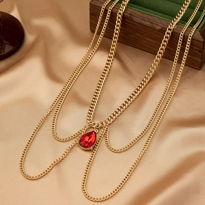Elegant multi-layer gold cuban body chain with a red teardrop-shaped gemstone pendant