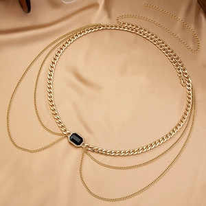 Elegant gold cuban chain waist belt with layered tassels and a rectangular black gemstone