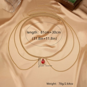 Detailed view of layered gold body chain with red teardrop gem and size dimensions