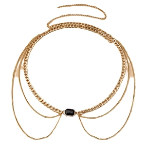 Luxurious layered gold chain body jewelry featuring an emerald cut black gemstone center