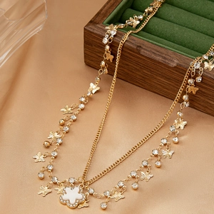 Collier multicouche doré exquis avec breloques papillon et pendentif trèfle blanc
