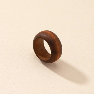 Minimalist dark brown walnut wood ring featuring natural grain in a rounded wide band design