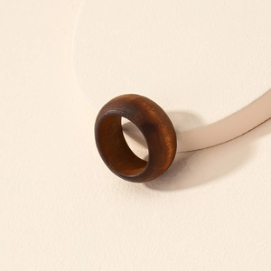 Minimalist vintage wooden ring featuring natural brown grain texture and polished wide band