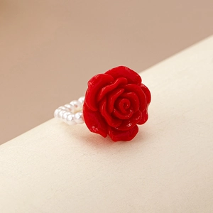 Close-up of the elegant 3D red resin rose and delicate pearl beaded band on this ring