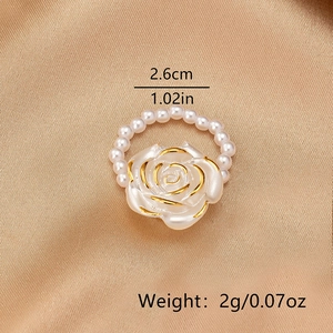 Detail view of white rose ring with gold edges and pearl chain showing 2.6cm size