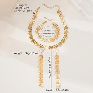 Detail view of gold Greek Key jewelry set showing necklace, bracelet and long earrings