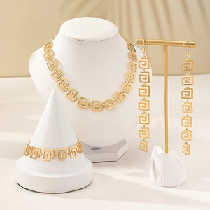 Golden jewelry set with Greek meander geometric pattern, necklace bracelet and earrings