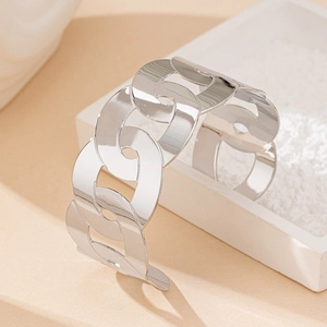 Detailed view of silver minimalist pig nose link bracelet on a white display box