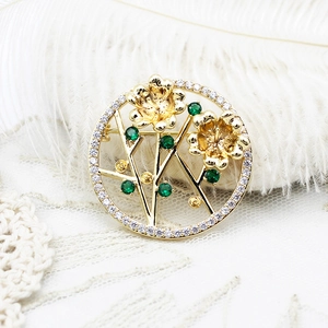 Exquisite 18K gold plated lotus flower brooch with white zircon pavé and green emerald accents