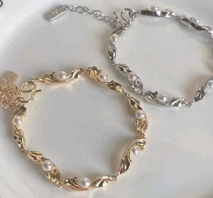 Elegant gold and silver wavy pearl bracelets with adjustable extension chain and charms