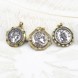 Macro view of vintage Greek coin pendants with embossed goddess portraits and gemstones