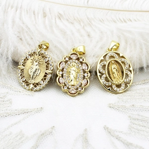 Close-up of 18k gold-plated Virgin Mary oval pendants with cubic zirconia inlay detail