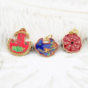 Macro shot of traditional enamel charms including Ruyi lock and Bagua symbols for DIY jewelry