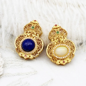 Detailed view of Chinese style gold filigree hollow gourd pendant with gemstones