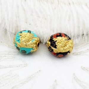 Macro detail of dragon enamel round beads for DIY jewelry with gold-plated finish