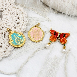 Exquisite gold-plated enamel charms with turquoise, pink, and butterfly floral pendants