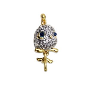 Two-tone bird pendant with micro-pave white cubic zirconia and blue gemstone eyes
