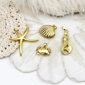 Polished 18K gold plated ocean theme pendants including starfish, shell, crab and mermaid