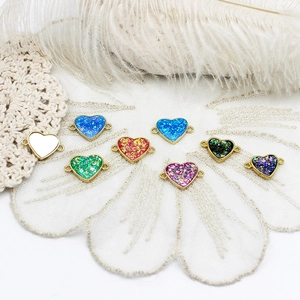 Close-up of colorful 18K gold plated heart charms with double loops for DIY jewelry