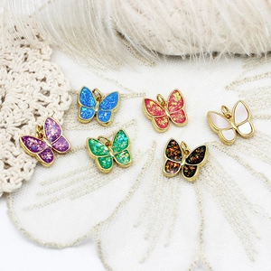 Detailed view of colorful butterfly charms with 18K gold plating for DIY jewelry projects