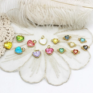 Macro detail of heart-shaped opal charms with 18K gold plating for DIY jewelry