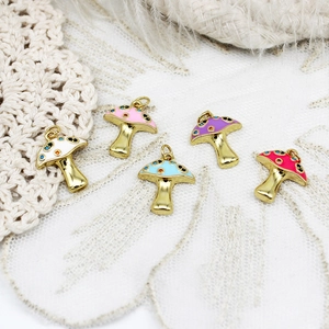 Macro shot of colorful mushroom enamel charms for DIY jewelry making with gold-plated finish
