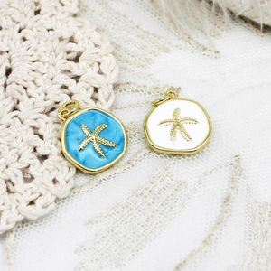 Macro shot of blue and white enamel starfish pendants with gold plated alloy edges