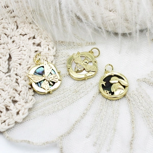 Detailed view of 18K gold-plated charms with butterfly bee and moon rabbit shell inlays